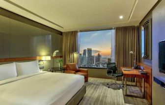 King bedroom with desk along the window at the Hilton Sukhumvit Bangkok.