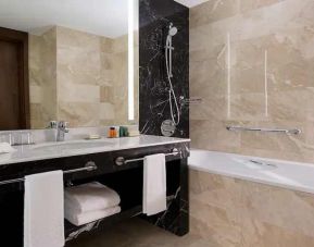 clean and spacious king bathroom with bath and shower at Hilton Astana.