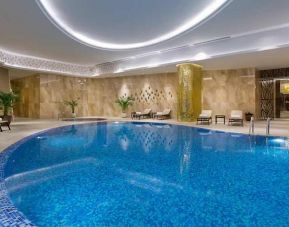 stunning indoor pool with sunbeds at Hilton Astana.