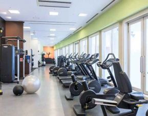 well equipped fitness center with treadmills, bicycles, and weights at Hilton Fukuoka Sea Hawk.