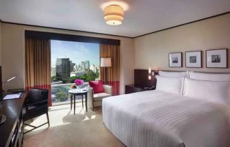 King bedroom with desk at the Conrad Bangkok.