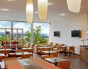 Seating area with TV screens at the Hilton Zurich Airport.