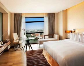 King guestroom with working station along the window at the Hilton Colombo Residence.