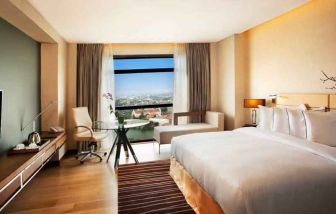 King guestroom with working station along the window at the Hilton Colombo Residence.