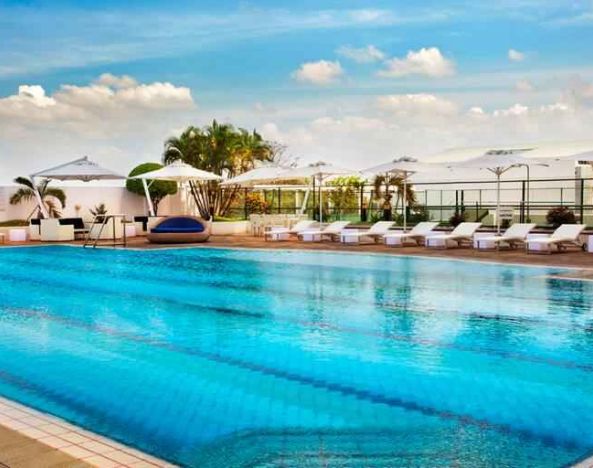 Relaxing outdoor pool area with lounges at the Hilton Colombo Residence.