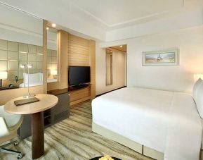 comfortable king room with TV, desk, and chair at DoubleTree by Hilton Riyadh - Al Muroj Business Gate.