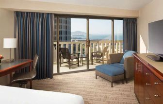 King bedroom with desk and balcony and at the Hyatt Regency San Francisco.