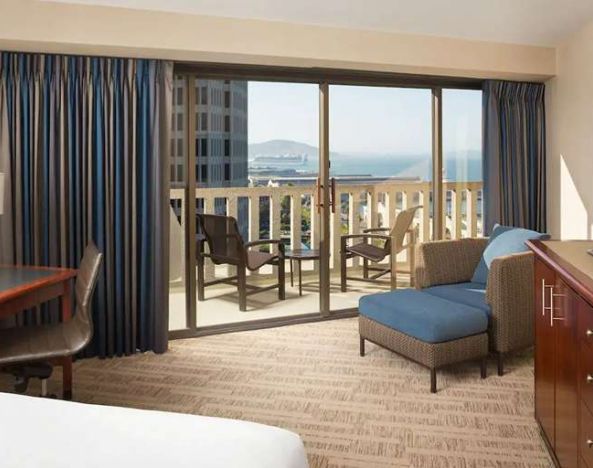 King bedroom with desk and balcony and at the Hyatt Regency San Francisco.