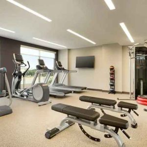 Fitness center with machines at Embassy Suites by Hilton Oahu Kapolei.