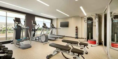 Fitness center with machines at Embassy Suites by Hilton Oahu Kapolei.