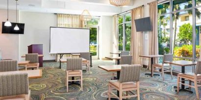 Bright meeting room with large windows at Embassy Suites by Hilton Oahu Kapolei.