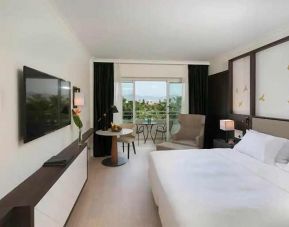 comfortable king room with TV and outdoor terrace at Hilton Nicosia.
