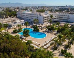 stunning outdoor pool surrounded with sunbeds and umbrellas at Hilton Nicosia.