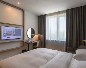 comfortable king suite with TV, work desk, and chair at Hilton Garden Inn Zagreb - Radnicka.