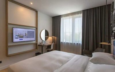 comfortable king suite with TV, work desk, and chair at Hilton Garden Inn Zagreb - Radnicka.