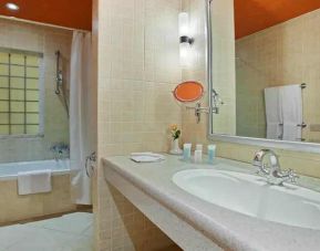 clean and spacious king bathroom with shower and bath combo at Hilton Alexandria Green Plaza.