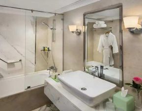 clean and spacious king bathroom with shower and bath combo at Hilton Alexandria Corniche.