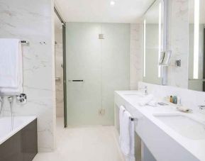 clean and spacious king bathroom with shower and bath at Hilton Tallinn Park.