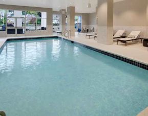 Gorgeous indoor pool with sun beds and seating at Embassy Suites by Hilton San Rafael Marin County.