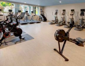 well-equipped fitness center with natural light at Embassy Suites by Hilton San Rafael Marin County.