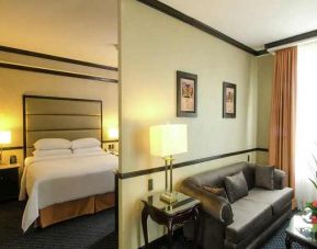 spacious king suite with comfortable lounge area at Hilton Princess San Pedro Sula.