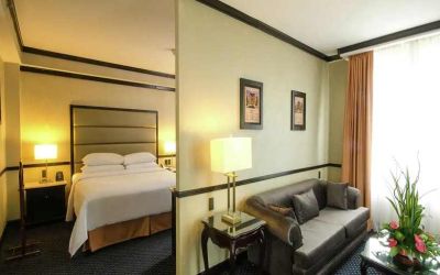 spacious king suite with comfortable lounge area at Hilton Princess San Pedro Sula.
