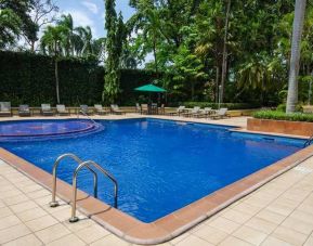 lovely outdoor pool with seating area and sun beds at Hilton Princess San Pedro Sula.