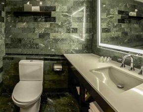 guest bathroom with basin, toilet, and shower at Hilton Garden Inn Guatemala City.