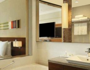 guest bathroom with bath and shower combo at Hilton Chennai.