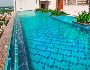 stunning outdoor pool with city views at Hilton Chennai.