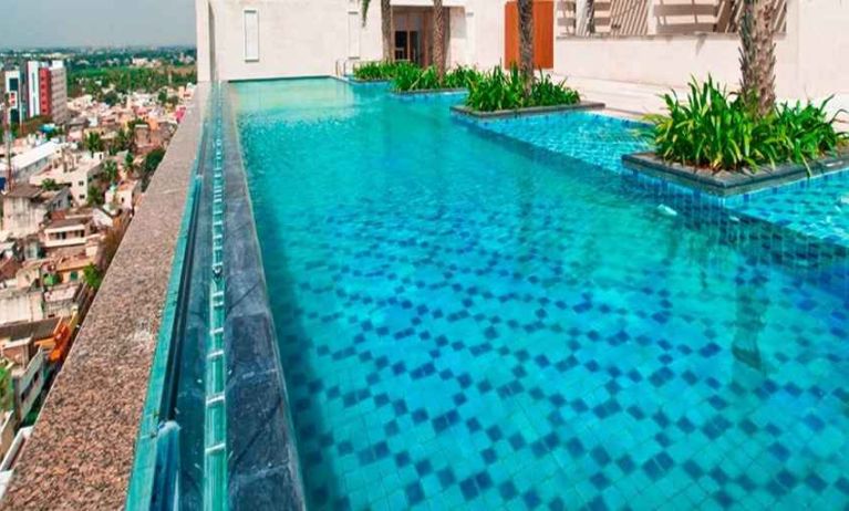 stunning outdoor pool with city views at Hilton Chennai.