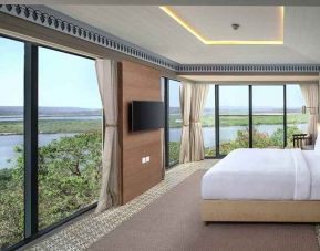 luxurious king suite with TV and gorgeous nature views at DoubleTree by Hilton Goa - Panaji.