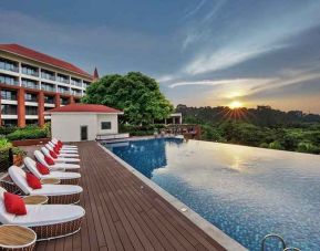 stunning outdoor infinity pool with sun beds at DoubleTree by Hilton Goa - Panaji.
