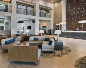 Lobby workspace with sofas at the Embassy Suites by Hilton Los Angeles Downey.