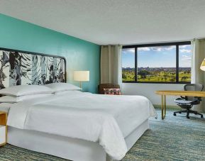King bedroom with desk at the Sheraton Miami Airport Hotel.