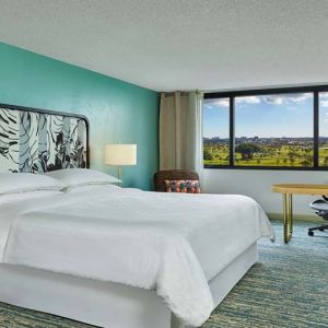 King bedroom with desk at the Sheraton Miami Airport Hotel.