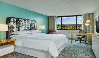 King bedroom with desk at the Sheraton Miami Airport Hotel.