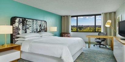 King bedroom with desk at the Sheraton Miami Airport Hotel.