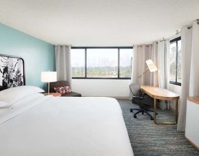 Hotel bedroom with working station and TV screen at the Sheraton Miami Airport Hotel.