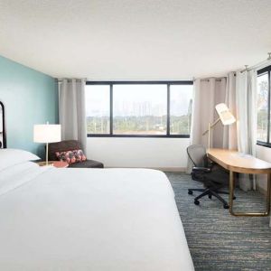 Hotel bedroom with working station and TV screen at the Sheraton Miami Airport Hotel.