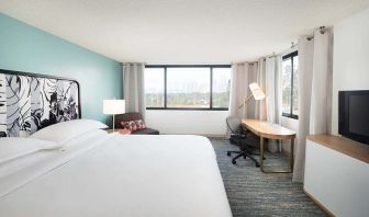 Hotel bedroom with working station and TV screen at the Sheraton Miami Airport Hotel.