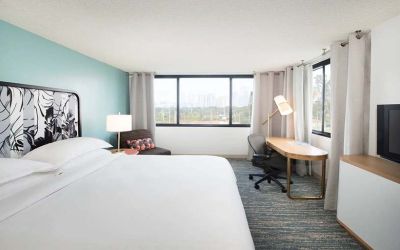Hotel bedroom with working station and TV screen at the Sheraton Miami Airport Hotel.