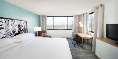 Hotel bedroom with working station and TV screen at the Sheraton Miami Airport Hotel.