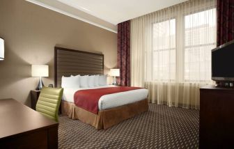 Hotel bedroom with working station at the Embassy Suites by Hilton St. Louis Downtown.