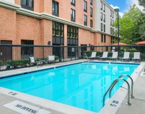 large outdoor pool with sunbeds and outdoor seating at Hampton Inn & Suites Annapolis.