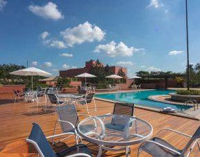 View of outside pool, deck and seating area to sunbathe.