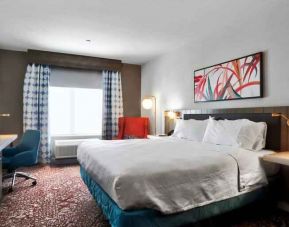 Queen size bed with work desk at Hilton Garden Inn Bel Air.
