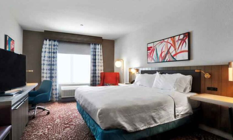 Queen size bed with work desk at Hilton Garden Inn Bel Air.
