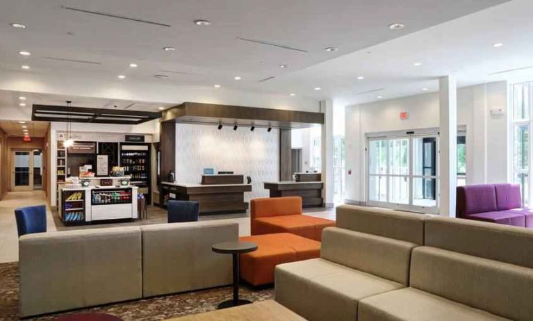Gray, salmon and purple colored couches decorate the lobby area of the Hilton Garden Inn Bel Air.