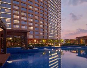 Relaxing outdoor pool at the Conrad Bengaluru.